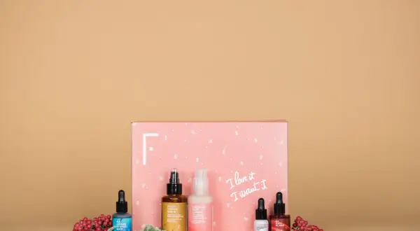 Caja rosa con productos de belleza y bayas rojas. ¡Las **productos freshly opiniones** son excelentes para esta rutina de cuidado de la piel!